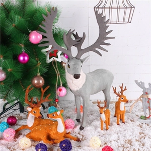 Christmas reindeer figurines set with grey buck and brown fawns in artificial snow