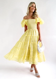 Close-up of yellow off-shoulder dress with puff sleeves and sheer checkered texture