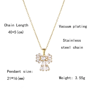 Detail view of gold bow necklace with zirconia pendant showing technical product dimensions