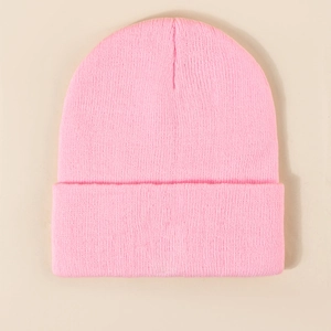 Detailed close-up of pink ribbed knit beanie showing high-quality texture and stitching