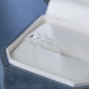 S925 sterling silver ring featuring three delicate plum blossoms on a blue velvet box