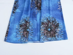 Macro shot of blue vacation set fabric showing large radial print and soft texture