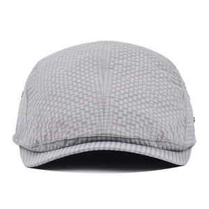 Macro shot of grey checkered flat cap fabric with detailed breathable texture and side buckle