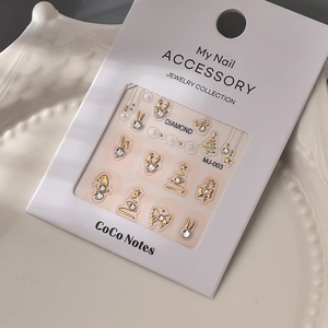 Macro view of Christmas nail art charms featuring gold snowman and deer designs