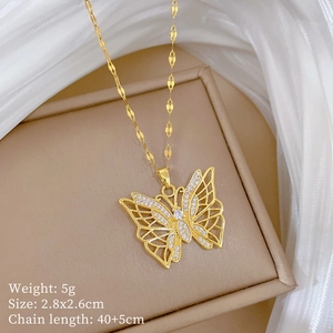 Detail of gold butterfly necklace with pavé zircons in a beige jewelry display box