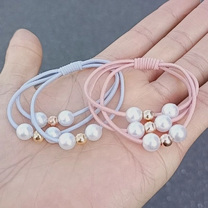 Pastel pink and blue pearl elastic hair ties with gold beads for women's ponytails