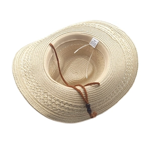 Beige straw cowboy hat with brown braided string and wooden beads on white background