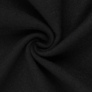 Close-up detail of premium black knitted fabric showing fine texture and breathable weave
