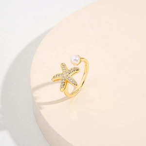 Adjustable 18K gold plated starfish ring with micro-pave crystals and a glossy pearl
