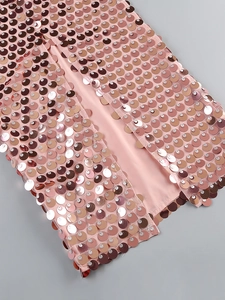 Detailed macro view of rose gold sequins with shimmering fishtail texture on evening gown