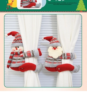 Detail of plush Christmas curtain tiebacks featuring Santa and Snowman with knitted textures