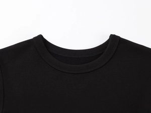 Détail de l'encolure ronde renforcée et de la texture en maille du t-shirt noir serré
