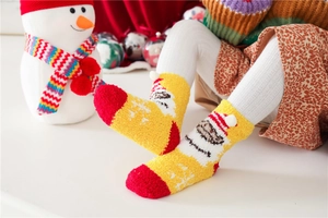 Close-up of cozy coral fleece Christmas socks worn by a child in a warm holiday setting