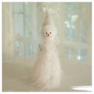 Close-up of a plush Christmas snowman ornament with a lace robe and carrot nose