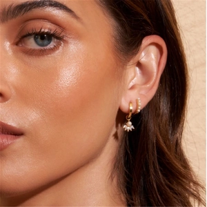 Close-up of model wearing 925 silver gold hoop earrings with pearl and marquise zircon