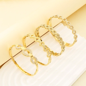 Elegant gold-plated stainless steel hollow bracelets with crystal inlay displayed at 45-degree angle