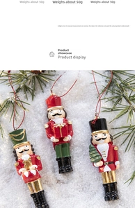 Close-up of three festive resin nutcracker ornaments on snow and pine branches