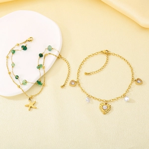 Detail of gold starfish anklet with green beads and heart-shaped zircon charms