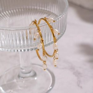 Detailed view of French vintage gold hoop earrings with natural freshwater pearls