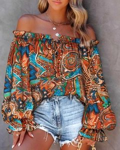 Detail view of bohemian print off-shoulder blouse with bell sleeves and ethnic patterns