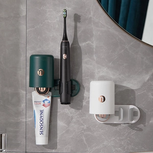 Wall-mounted dark green and white toothbrush holder with magnetic cups and rack