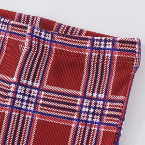 Girls red plaid knit leggings with elastic waistband and vertical ribbed texture