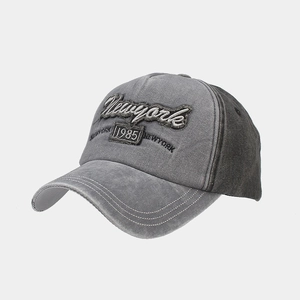 Detailed macro shot of vintage washed cotton baseball cap with Newyork 1985 embroidery