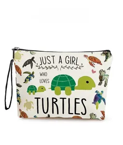 Detail of canvas makeup bag featuring colorful turtle prints and Just a Girl slogan