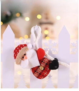Close-up of fabric Santa Claus ornament with red plaid details and white hanging rope