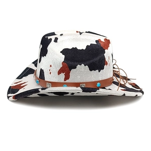 Western cowboy hat with cow print, brown leather band, and turquoise bead accents