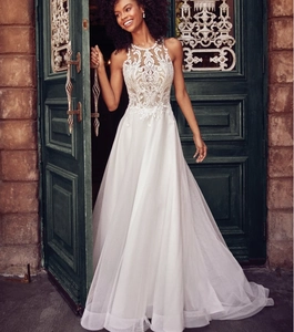 Detail of white lace floral embroidery and sheer illusion neck on elegant bridal gown