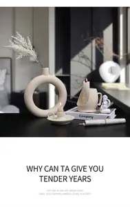 Nordic matte ceramic candle holder set and circular vase with dried flowers on a table