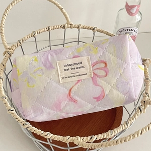 Macro view of floral quilted cotton makeup bag with yellow butterflies and pink bow