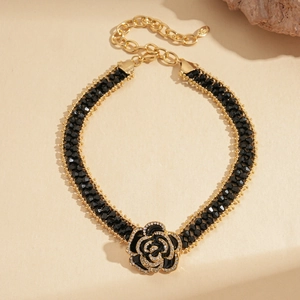 Detail of a black rose choker featuring faceted beads and sparkling rhinestone accents