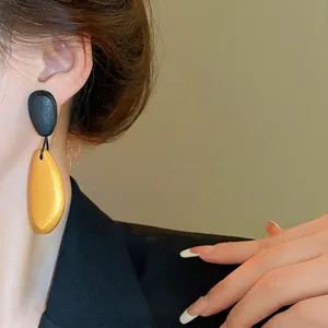 Retro irregular oval wooden drop earrings with silver needle and matte contrast finish