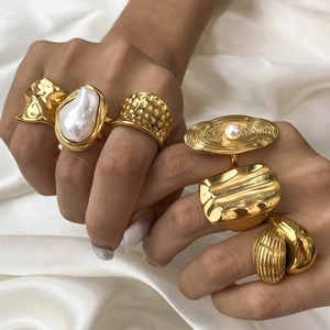 Baroque style 18k gold plated irregular rings set with pearls on white silk fabric