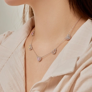 Close-up of S925 silver necklace featuring five colorful heart-shaped zircon pendants