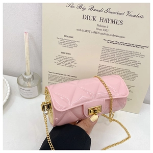 Detail of pink quilted cylinder bag with gold chain strap and large pearl accent