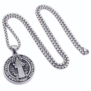 Vintage stainless steel round medallion pendant with religious embossing on a box chain