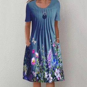 Detail showing the floral print on the summer dress with functional side pockets