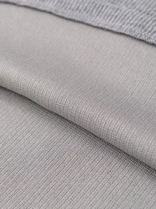 Macro shot of grey soft knit fabric texture with ribbed edge detail for the dress