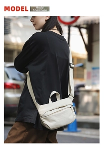Detail view of the beige nylon crossbody bag showing the adjustable strap and zipper pocket