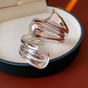 Macro shot of silver irregular wavy metal bracelet in a premium jewelry gift box