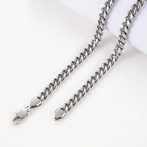 Detailed macro view of the silver stainless steel curb chain with a secure lobster clasp