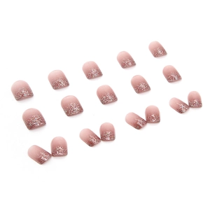 Short square press-on nails with nude pink gradient and sparkling silver glitter chips