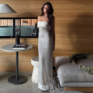 Detail showing the white strapless bodice and silver sequin texture on long dress