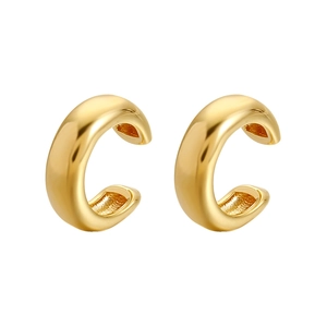 Detailed view of two polished gold-tone streamlined C-shaped cuff earrings on white background