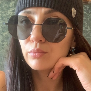 Close-up of octagonal black metal frame sunglasses with minimalist vintage design