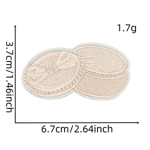 Detailed dimensions of beige embroidered bow patch measuring 6.7cm by 3.7cm