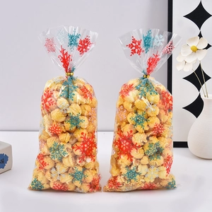 Sachets cadeaux de Noël transparents avec flocons et attaches dorées pour bonbons